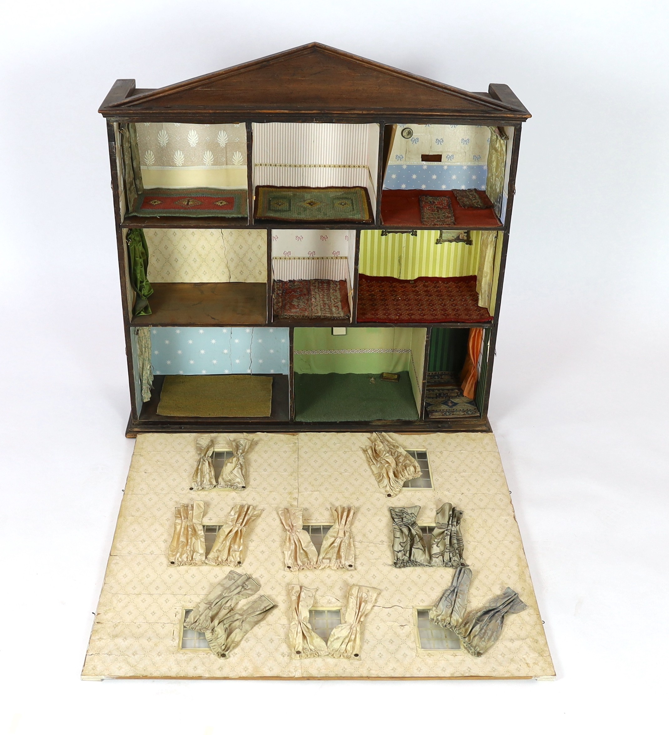 A furnished English dolls’ house, circa 1810-20, 104cm high